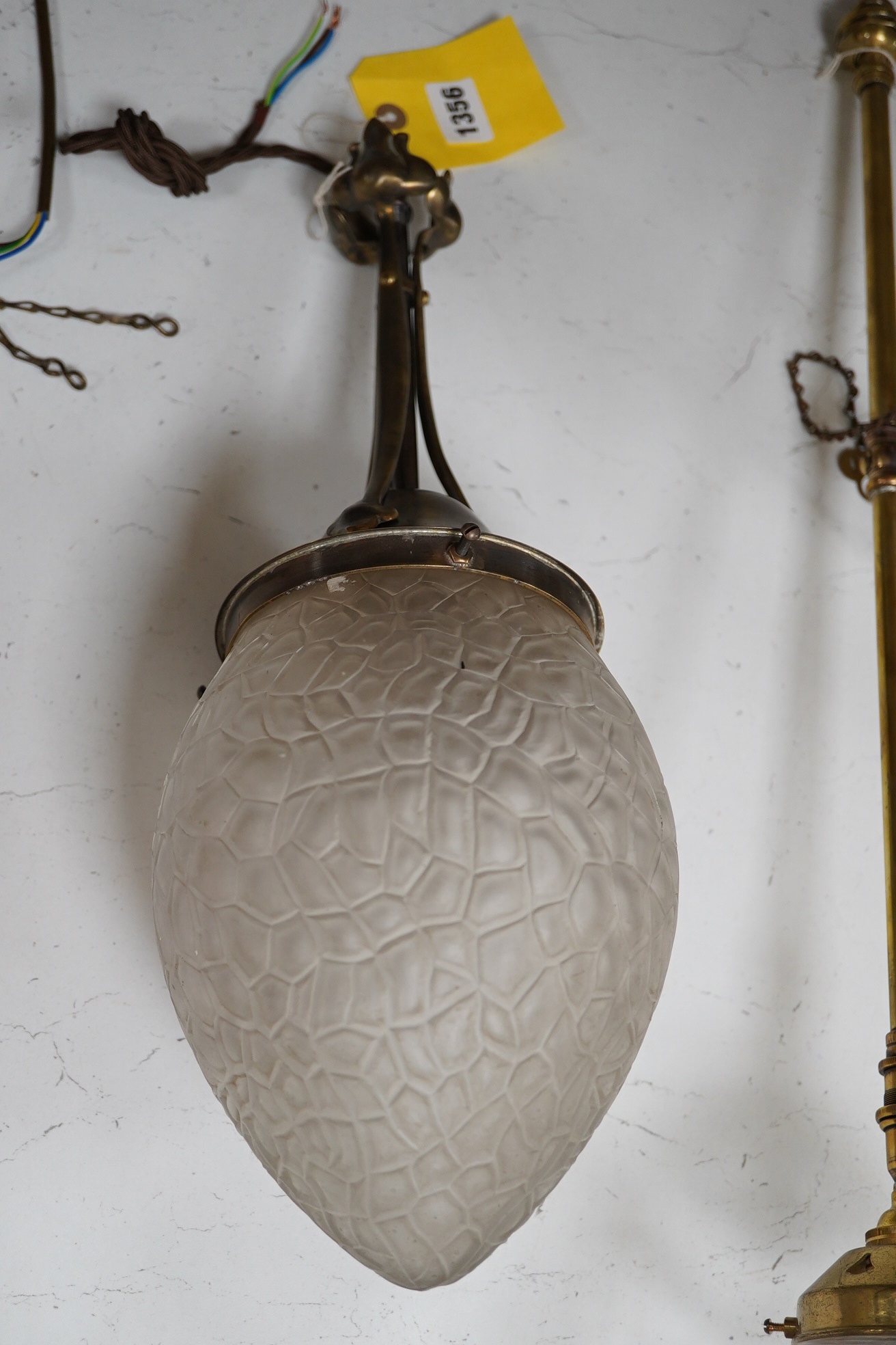 An English Arts and Crafts antique brass pendant with frosted glass shade, early 20th century, wired, overall 42cm high, glass 16cm high. Condition - fair to good